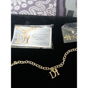 Goldtone charm bracelet free charm